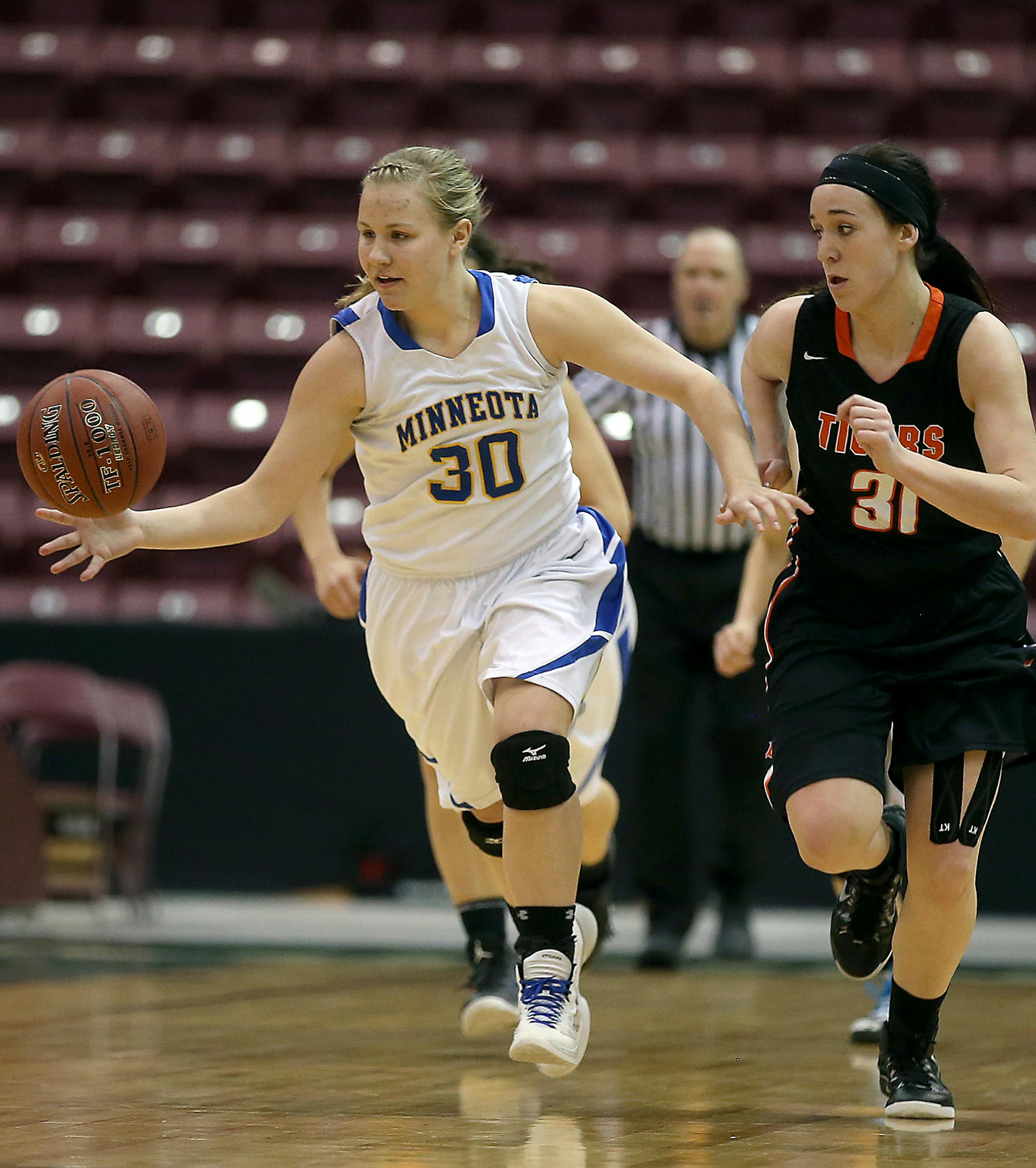 Minneota's LeAnn Jerzak drove down court with Browerville's Crystal Pearson playing defense in the second half of the game. Minnesota defeated Browerville 69-68 of the Class 1A girls' basketball quarterfinals, Thursday, March 19, 2015 at Mariucci Arena in Minneapolis, MN. [ELIZABETH FLORES • eflores@startribune.com]