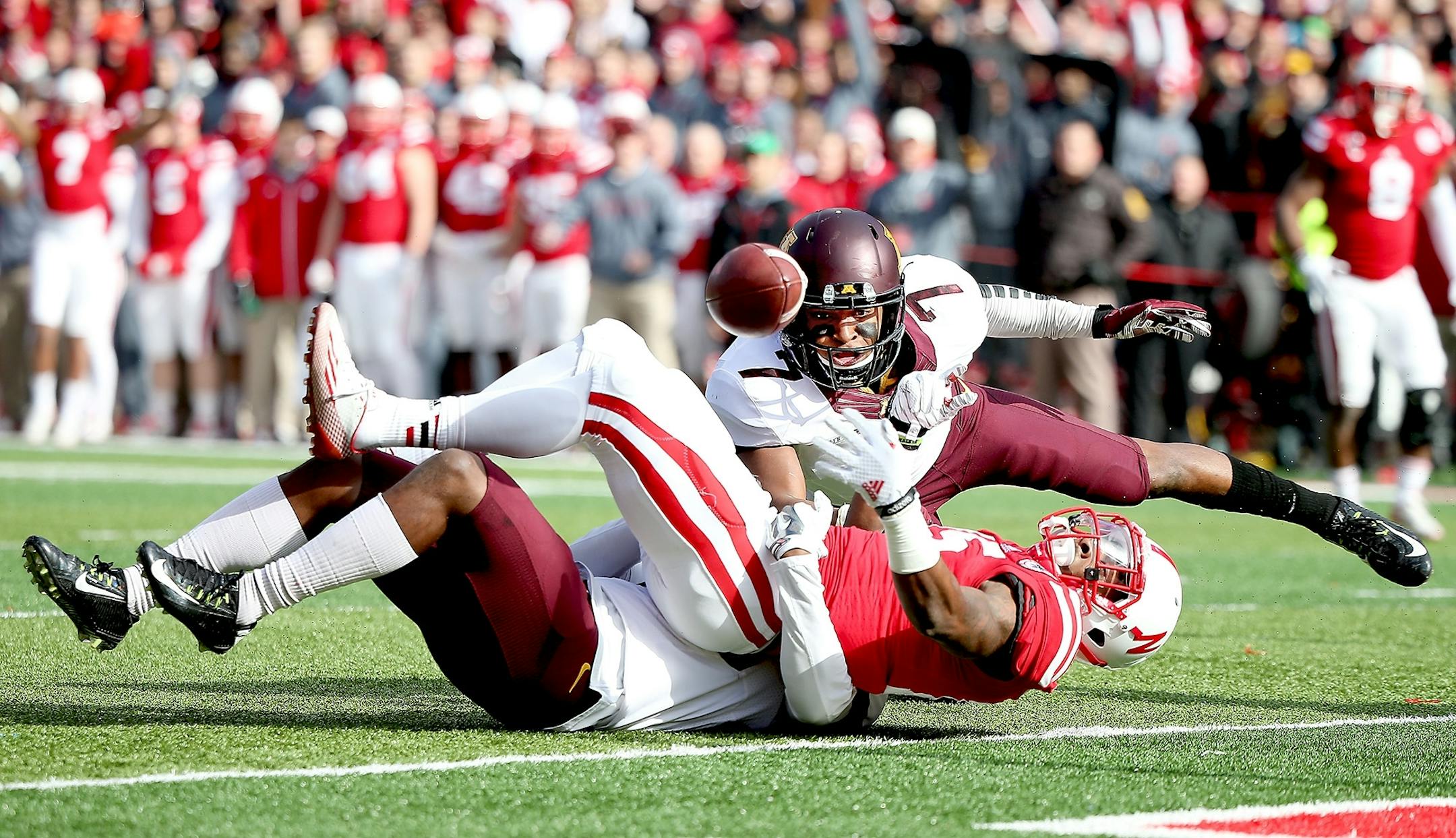 Minnesota's defensive back Damarius Travis (7) tackled Nebraska's wide receiver De'Mornay Pierson-El (15) but it was called a touchdown in the second quarter as the Minnesota Gophers took on the Nebraska Cornhuskers at Memorial Stadium, Saturday, November 22, 2014 in Lincoln, NE.