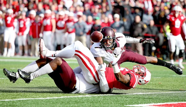 Minnesota's defensive back Damarius Travis (7) tackled Nebraska's wide receiver De'Mornay Pierson-El (15) but it was called a touchdown in the second 
