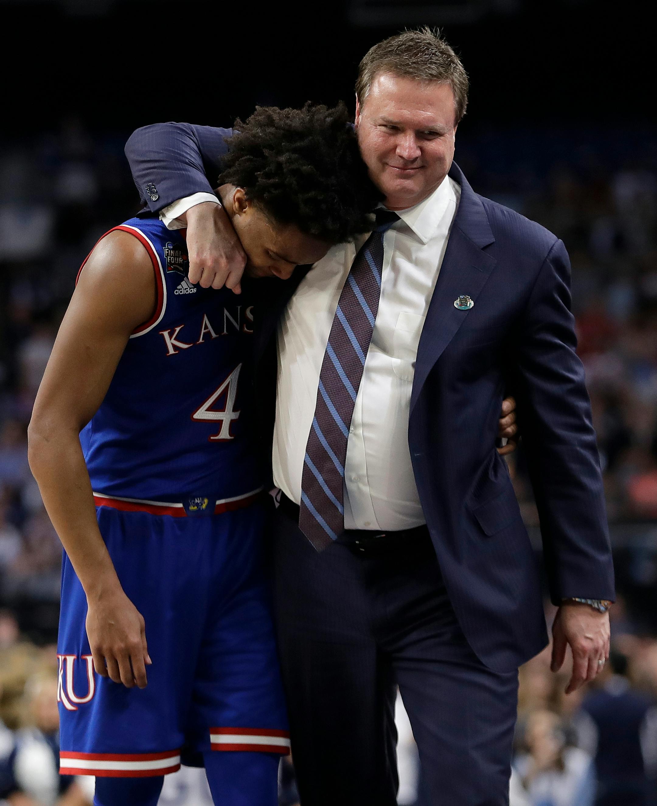 Kansas head coach Bill Self, right hugs Devonte' Graham (4) after the semifinals of the Final Four NCAA college basketball tournament against Villanova, Saturday, March 31, 2018, in San Antonio. Villanova won 95-79. (AP Photo/Eric Gay)