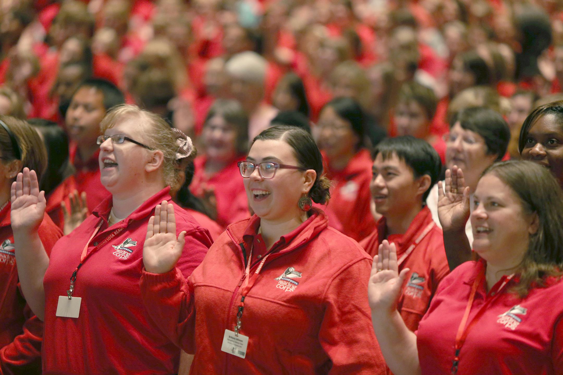 Brittany Johnson, center, joined more than 1,000 tutors from around Minnesota to take the AmeriCorps pledge to celebrate the 10th anniversary of the Minnesota Reading Corps at the Minneapolis Convention Center, Tuesday, August 20, 2013 in Minneapolis, MN. The event was to officially kick off the 2013-14 school year with Minnesota Education Commissioner Brenda Cassellius. (ELIZABETH FLORES/STAR TRIBUNE) ELIZABETH FLORES ¥ eflores@startribune.com