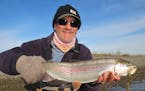 Chris Niskanen with a rainbow trout caught in Alaska. Niskanen, previously the St. Paul Pioneer Press outdoors columnist, has been the DNR communicati