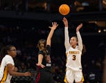Gophers guard Amaya Battle sank a three-pointer over Rutgers guard Antonia Bates during the fourth quarter.