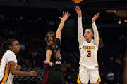 Gophers guard Amaya Battle sank a three-pointer over Rutgers guard Antonia Bates during the fourth quarter.