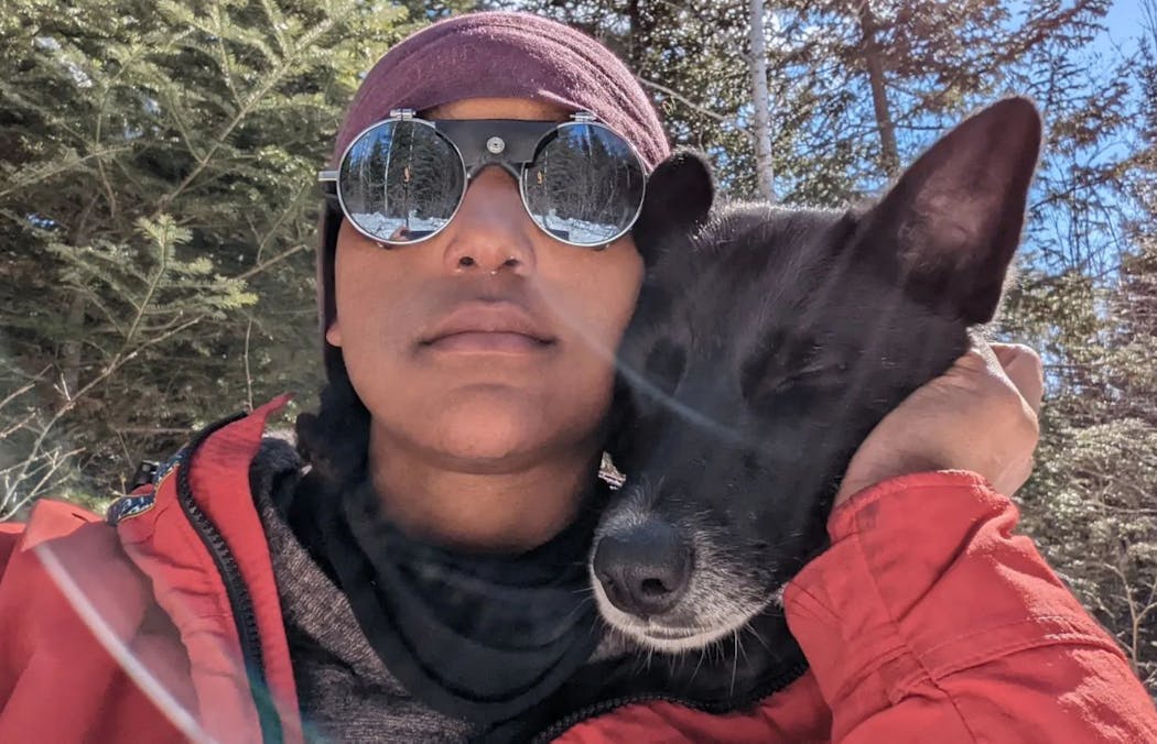 Emily Ford with her sled dog, Diggins, on a break during their journey on skis across the Boundary Waters Canoe Area Wilderness. 