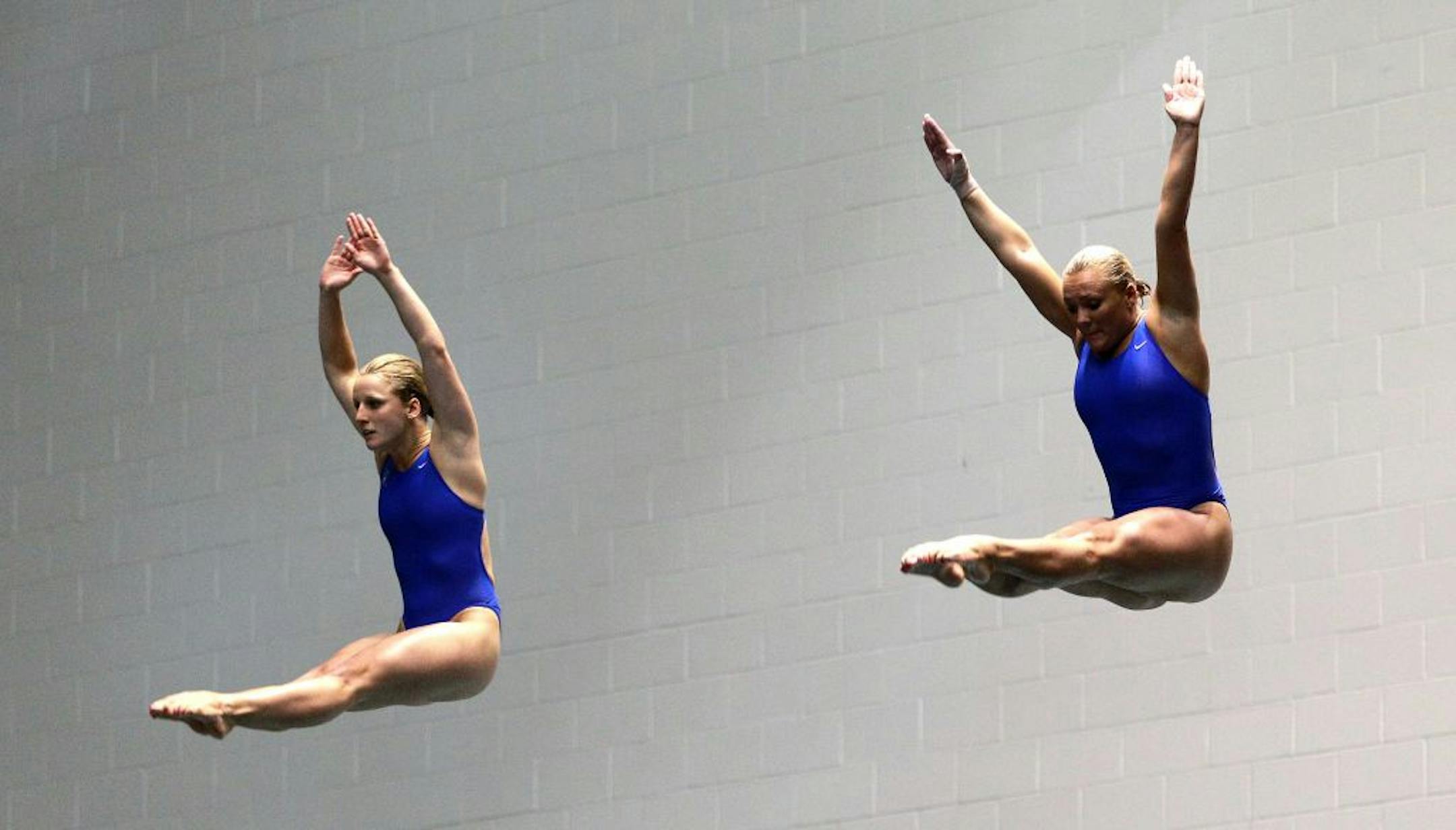 Abby Johnston, left, and Kelci Bryant begin a dive in the women's three-meter springboard synchro final at the U.S. Olympic diving trials on Thursday, June 21, 2012, in Federal Way, Wash. The two won the event.