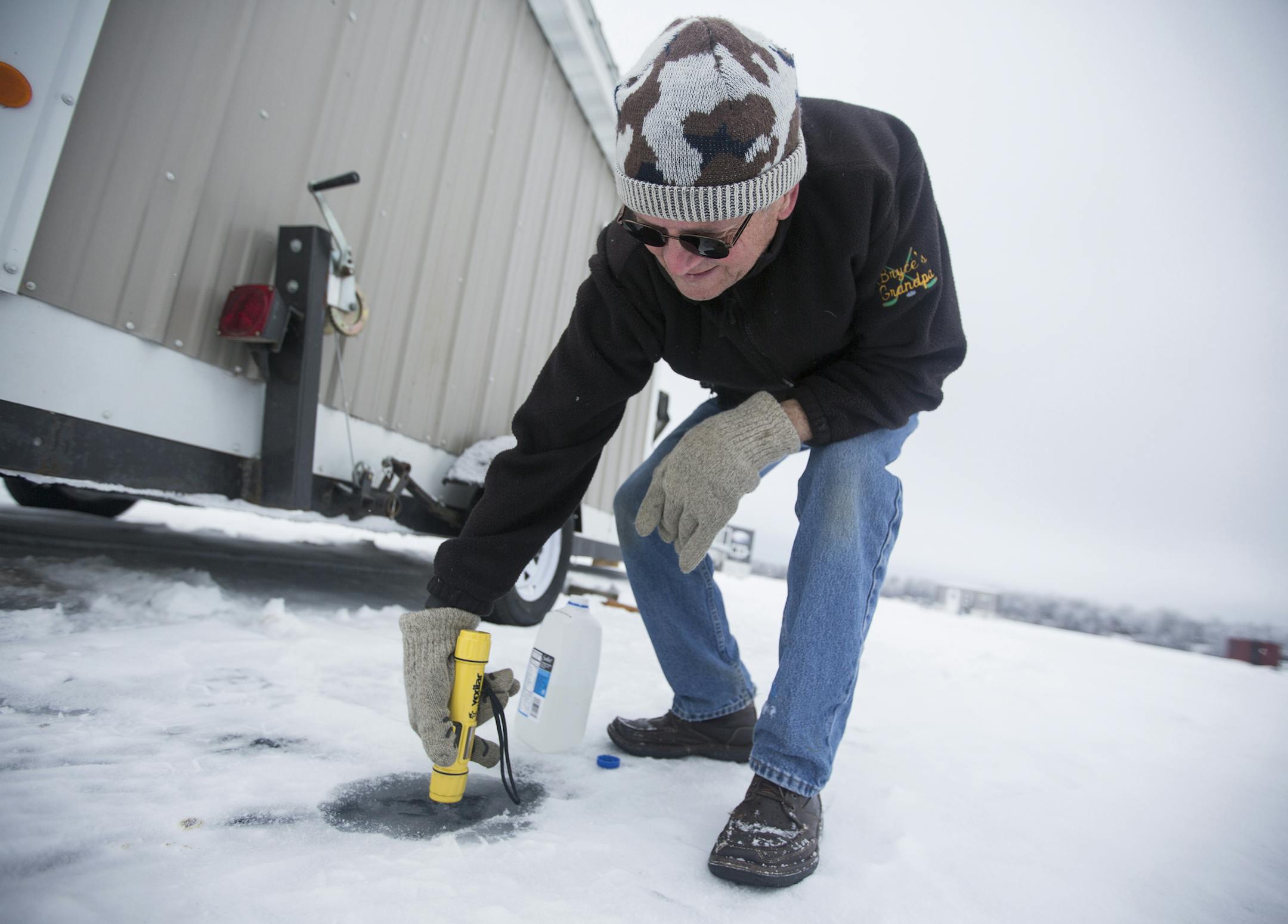 Randy Kirt, who owns a cabin on Round Lake, tests the depth of water on North Long Lake in the Brainerd Lakes area on Thursday, January 21, 2016. ] (Leila Navidi/Star Tribune) leila.navidi@startribune.com