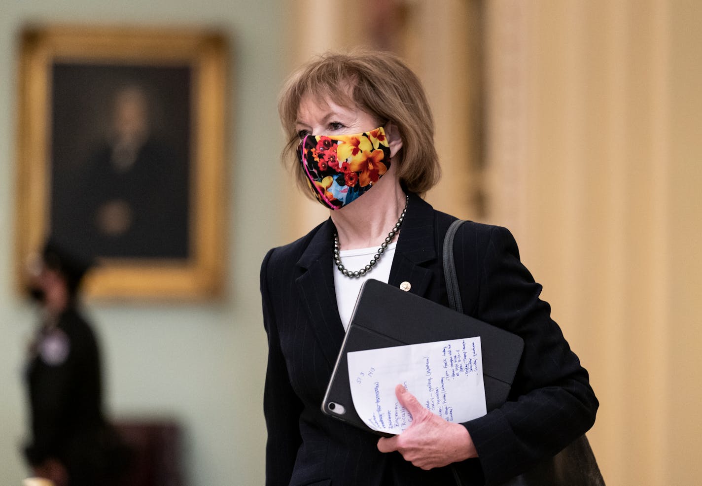 Sen. Tina Smith, D-Minn., arrives as opening arguments begin in former President Donald Trump's impeachment trial, at the Capitol in Washington, Wednesday, Feb. 10, 2021. (AP Photo/J. Scott Applewhite)