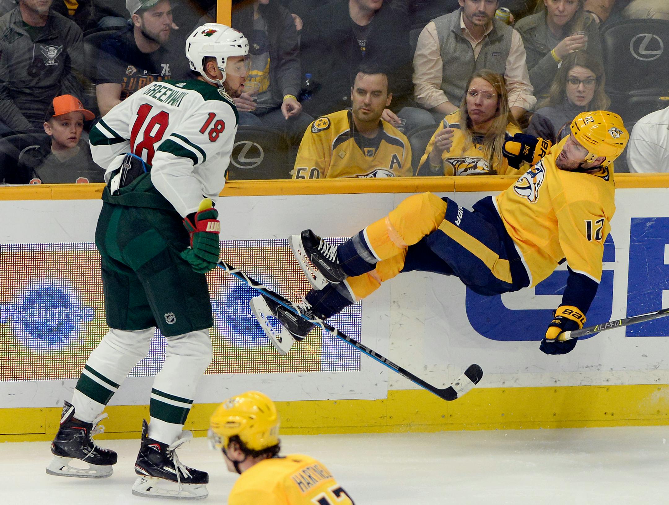 Minnesota Wild left wing Jordan Greenway (18) checks Nashville Predators center Mike Fisher (12) during the second period of an NHL hockey game Tuesday, March 27, 2018, in Nashville, Tenn. (AP Photo/Mark Zaleski)