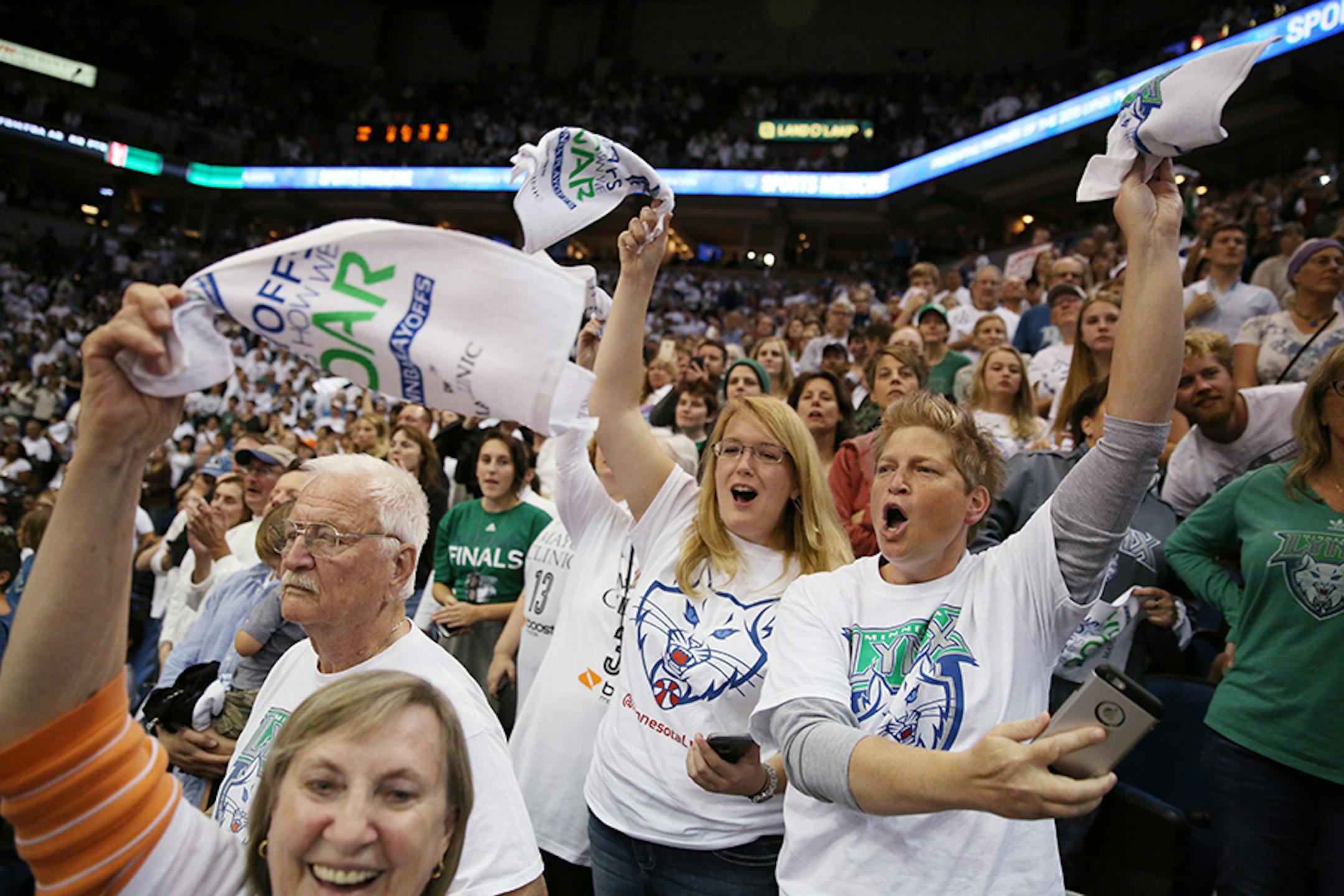 Jeanne Wodarz of White Bear Lake, right, and Kristin Magoris of Minneapolis celebrate the Minnesota Lynx winning the WNBA title.