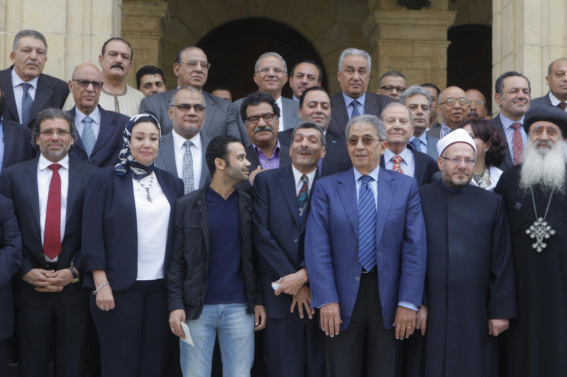 Egypt's 50-member panel that amended a constitution drafted under now-ousted Islamist President Mohammed Morsi, pose for photographers after finishing the final draft of a series of constitutional amendments outside the Shoura Council in Cairo, Egypt, Monday, Dec. 2, 2013. Adoption of the new charter will be a giant step in the implementation of the roadmap announced by the nation's military chief when he toppled Morsi in a July 3 coup. The next steps will be parliamentary and presidential elect