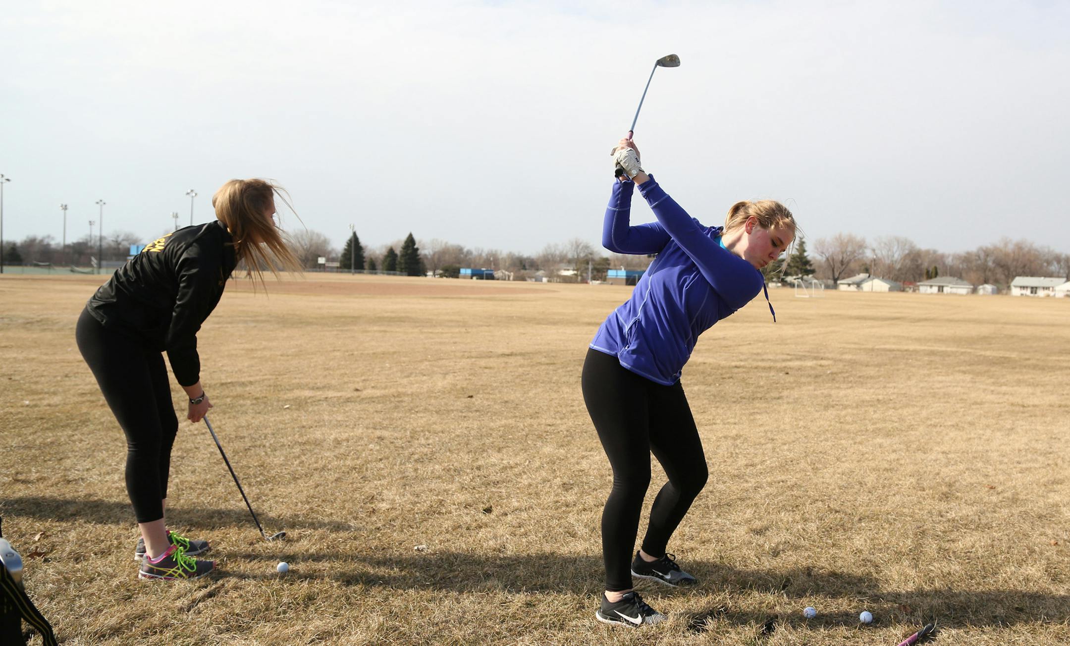 Christina Collins hit her golf balls toward a soccer net with the rest of the team during practice. ] (KYNDELL HARKNESS/STAR TRIBUNE) kyndell.harkness@startribune.com Fridley girls golf practice inFridley Min., Saturday, March19, 2015