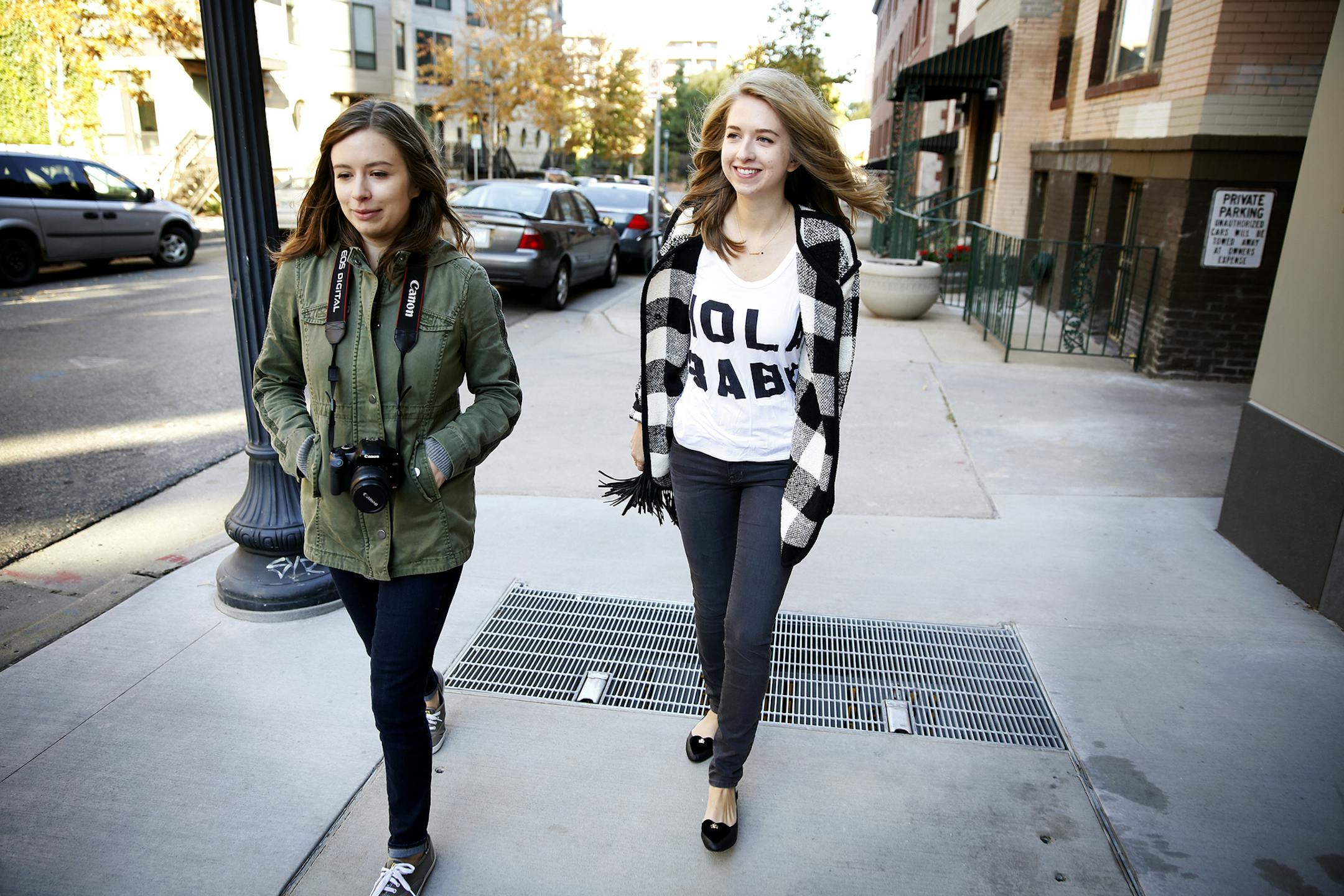 Local fashion blogger Chelsea Lankford, right, walks with her sister Caitlin Fultz to take photos for her blog "Zipped" in downtown Minneapolis. ] LEILA NAVIDI leila.navidi@startribune.com / BACKGROUND INFORMATION: Saturday, October 11, 2014. Chelsea Lankford is a fashion blogger who posts photos of herself in her latest outfit, often daily, on Instagram, where she has almost 40,000 followers, and her "Zipped" blog, which has about 50,000 visitors per month. She gets five to ten boxes of free cl