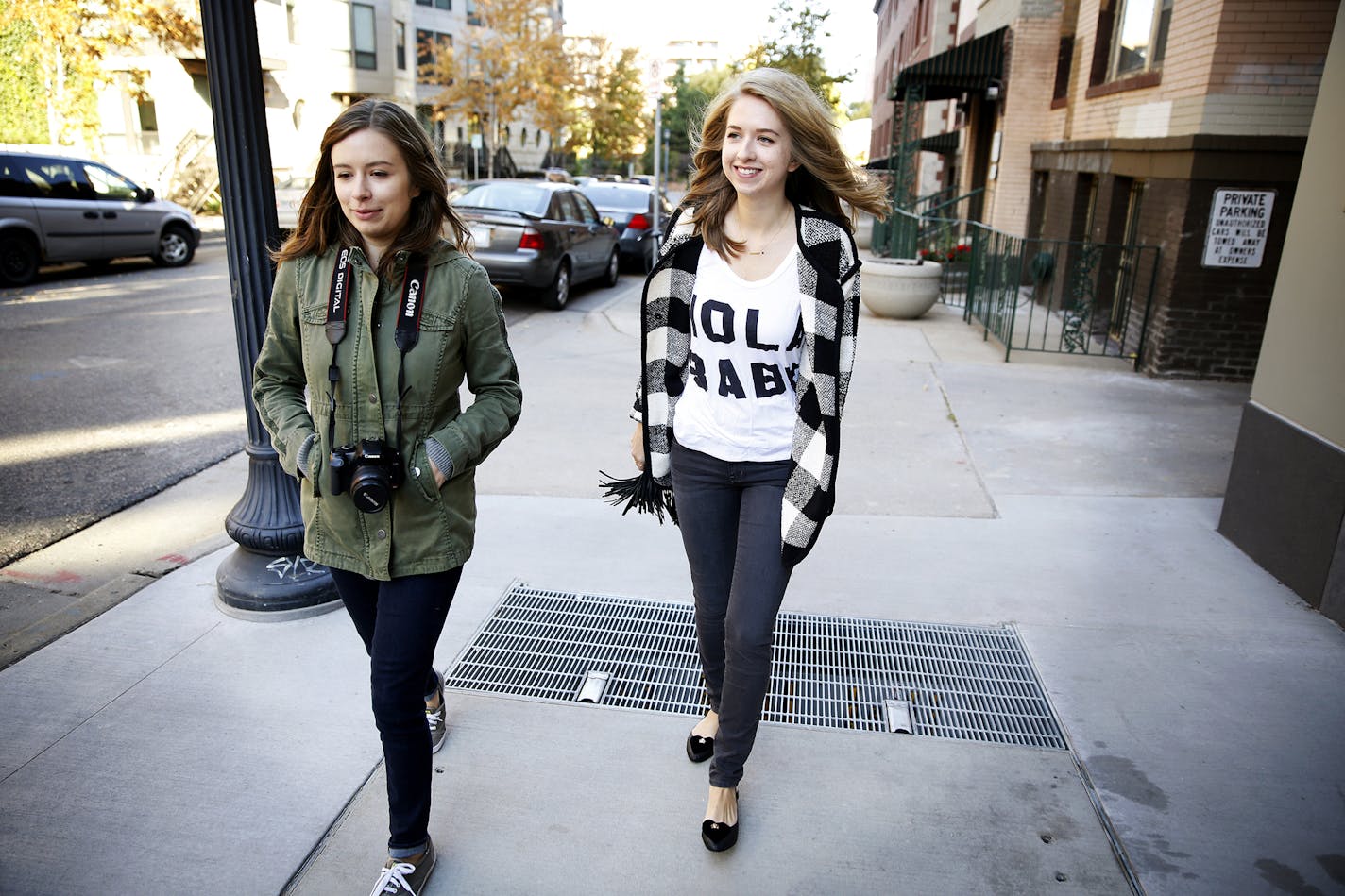 Local fashion blogger Chelsea Lankford, right, walks with her sister Caitlin Fultz to take photos for her blog "Zipped" in downtown Minneapolis. ] LEILA NAVIDI leila.navidi@startribune.com / BACKGROUND INFORMATION: Saturday, October 11, 2014. Chelsea Lankford is a fashion blogger who posts photos of herself in her latest outfit, often daily, on Instagram, where she has almost 40,000 followers, and her "Zipped" blog, which has about 50,000 visitors per month. She gets five to ten boxes of free cl