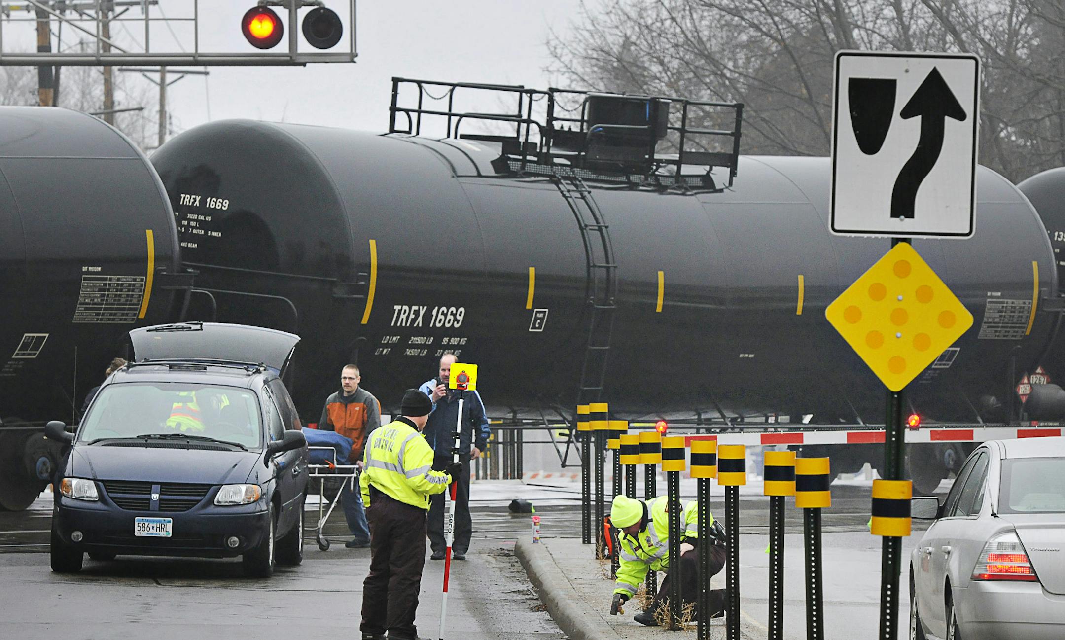 The Minnesota State Patrol investigates the scene after a pedestrian was hit by a train Thursday, March 27, 2014 at the Seventh Street Southeast train crossing near Lincoln Avenue in St. Cloud, Minn. The incident happened about 7 a.m. Thursday. (AP Photo/St. Cloud Times, Jason Wacher)