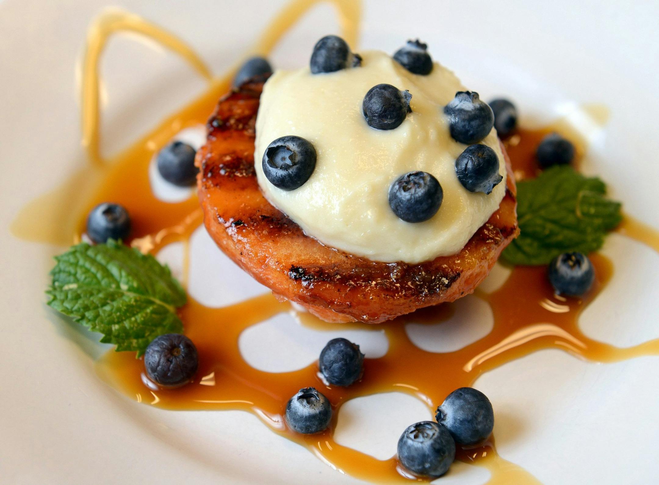Grilled peaches with alumond paste filling prepared by chef Adrianna Oropeza at Sierra Nut House in Fresno, California, on July 11, 2103. Grilling fruit can be a great way to enjoy seasonal bounty. (Craig Kohlruss/Fresno Bee/MCT) ORG XMIT: 1141095