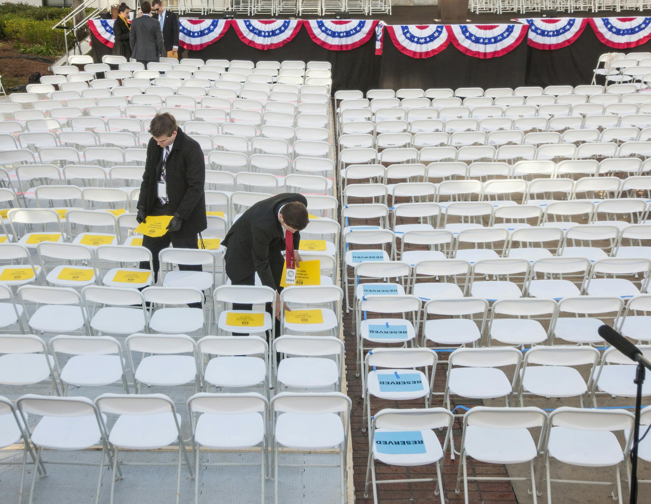 Governor's staff members mark the gold VIP seating section prior to the inauguration of Rick Scott as Florida's governor for a second term at the Florida state capitol in Tallahassee, Fla., Monday Jan. 06, 2015. (AP Photo/Mark Wallheiser)
