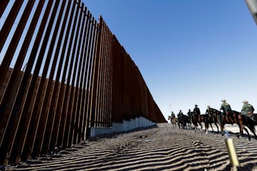 Mounted Border Patrol agents ride along a newly fortified border wall structure Friday, Oct. 26, 2018, in Calexico, Calif. (AP Photo/Gregory Bull)