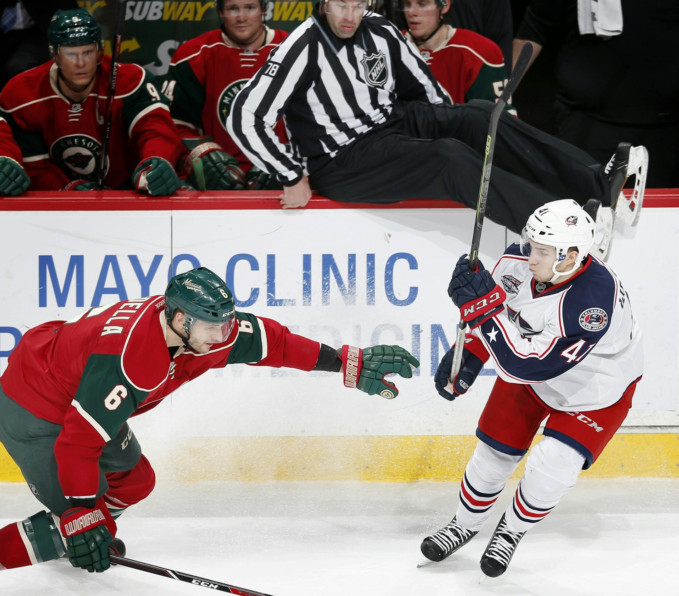 Linesman Brian Mach (78) got out the way of a puck that Marco Scandella (6) and Alexander Wennberg (41) in the second period.