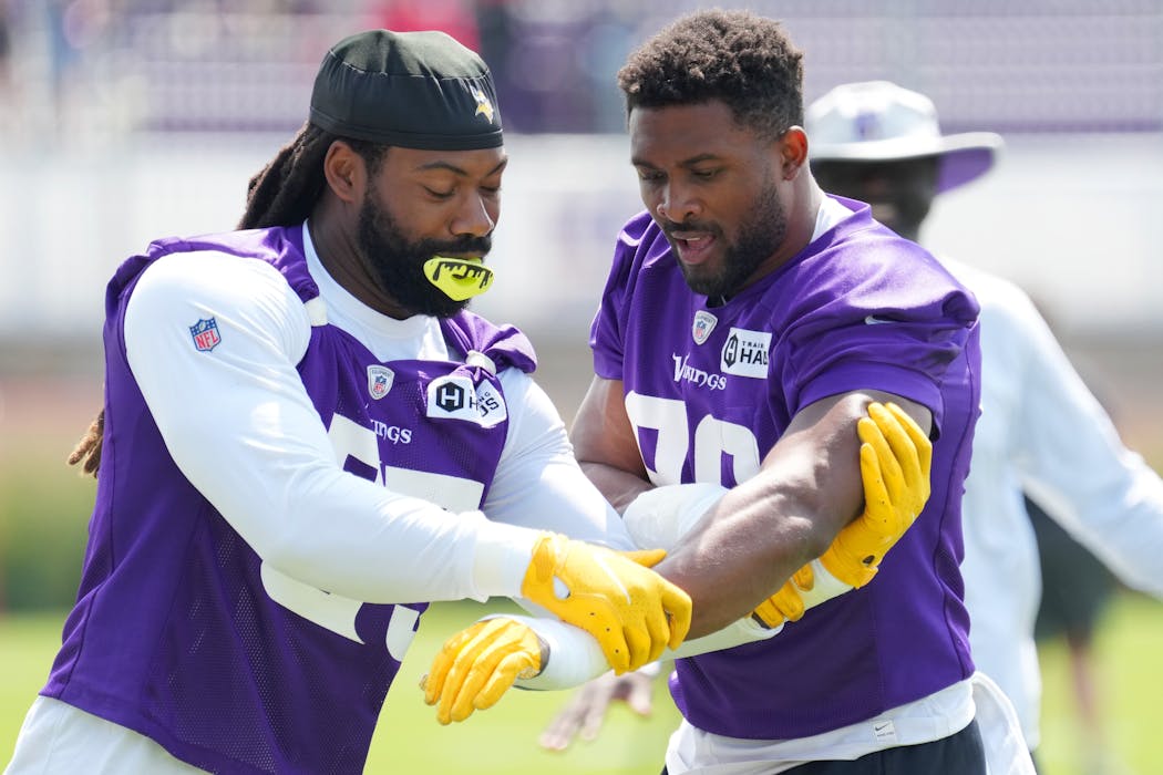 Smith, left, and Hunter are often seen working together off the field during practice.