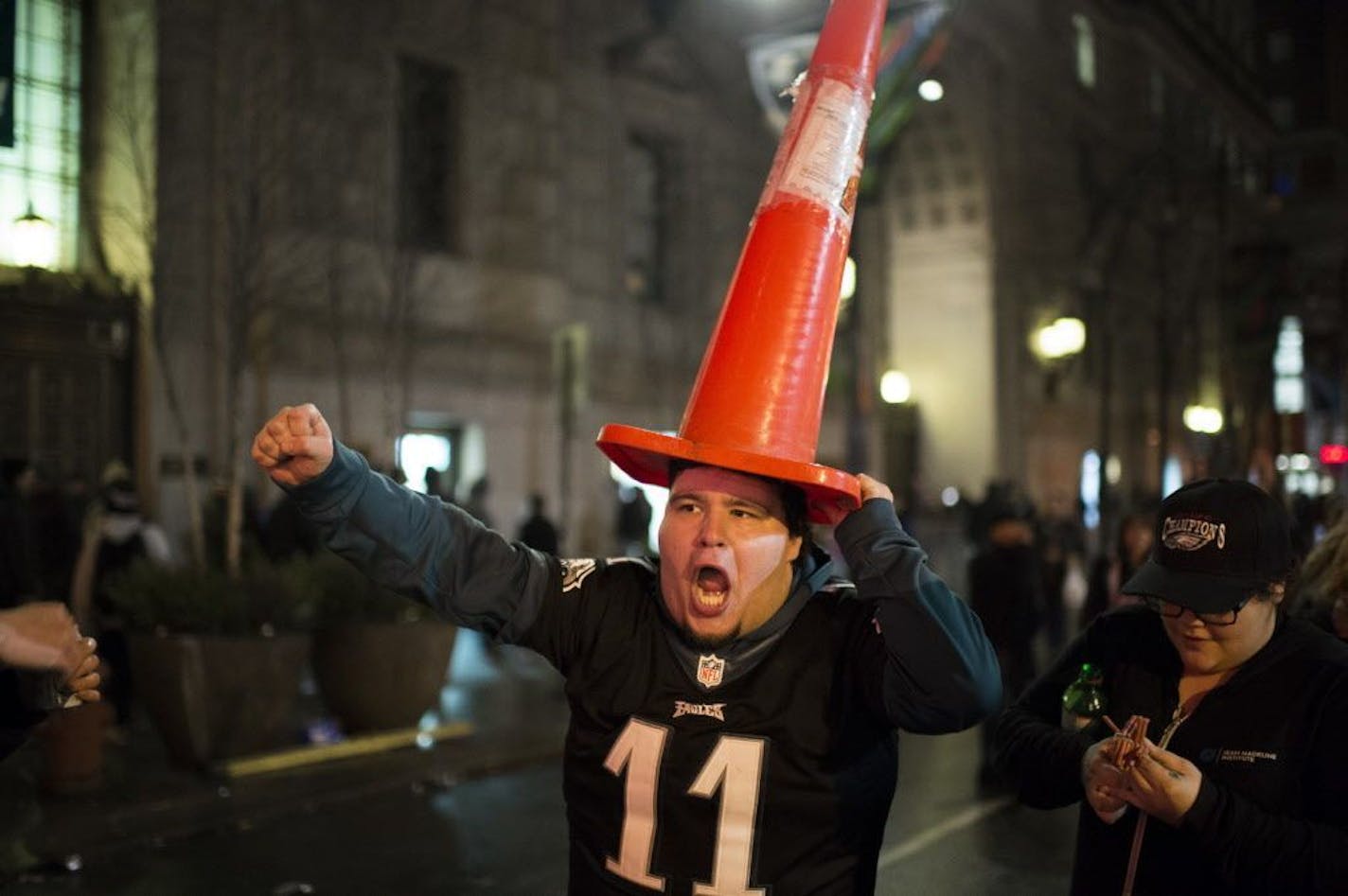 A Philadelphia Eagles fan marches with a cone on his head in downtown Philadelphia as fans celebrate the team's victory in the NFL Super Bowl 52 football game between the Eagles and the New England Patriots, in downtown Philadelphia Sunday, Feb. 4, 2018.