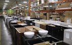 Rows of bathroom vanities in MN Home Outlet's warehouse location.