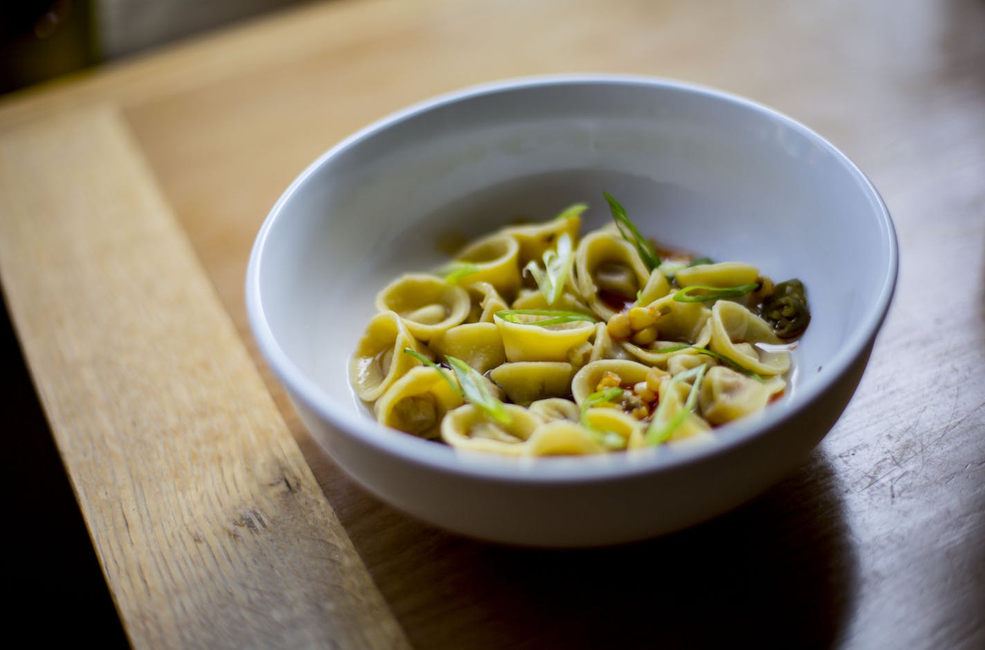 Tortellini is one of the restaurant's signature appetizers. ] ALEX KORMANN &#x2022; alex.kormann@startribune.com The Bungalow Club is a new local restaurant on E Lake Street that opened in April. The joint boasts a pasta-centric menu with specialties like octopus salad, gem lettuce salad, tortellini, mezzalune, smoked chicken and peach pie. One of the owners, Andrew Kraft is also the chef who is in the back helping make most meals.