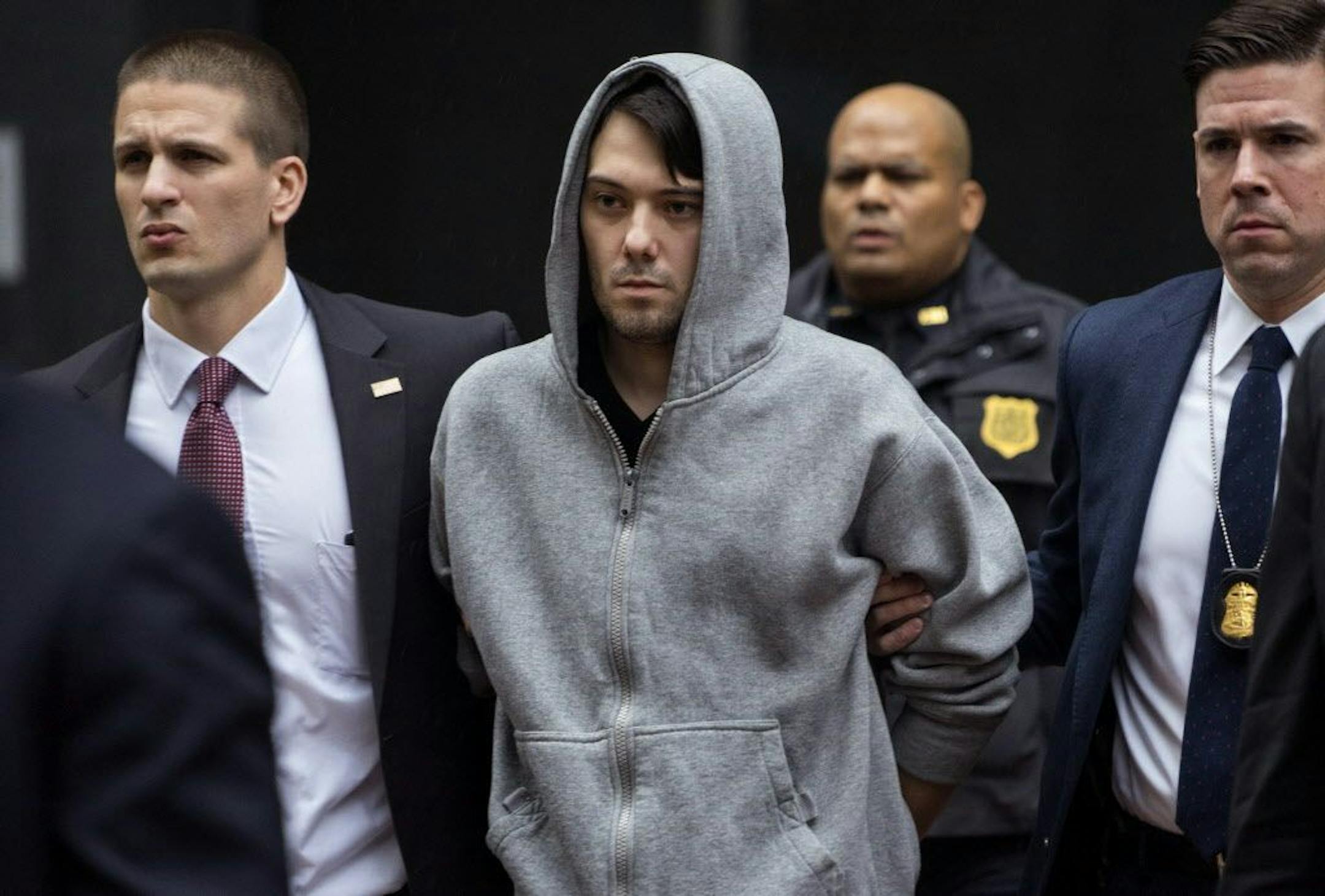 Martin Shkreli, the former hedge fund manager under fire for buying a pharmaceutical company and ratcheting up the price of a life-saving drug, is escorted by law enforcement agents in New York Thursday.