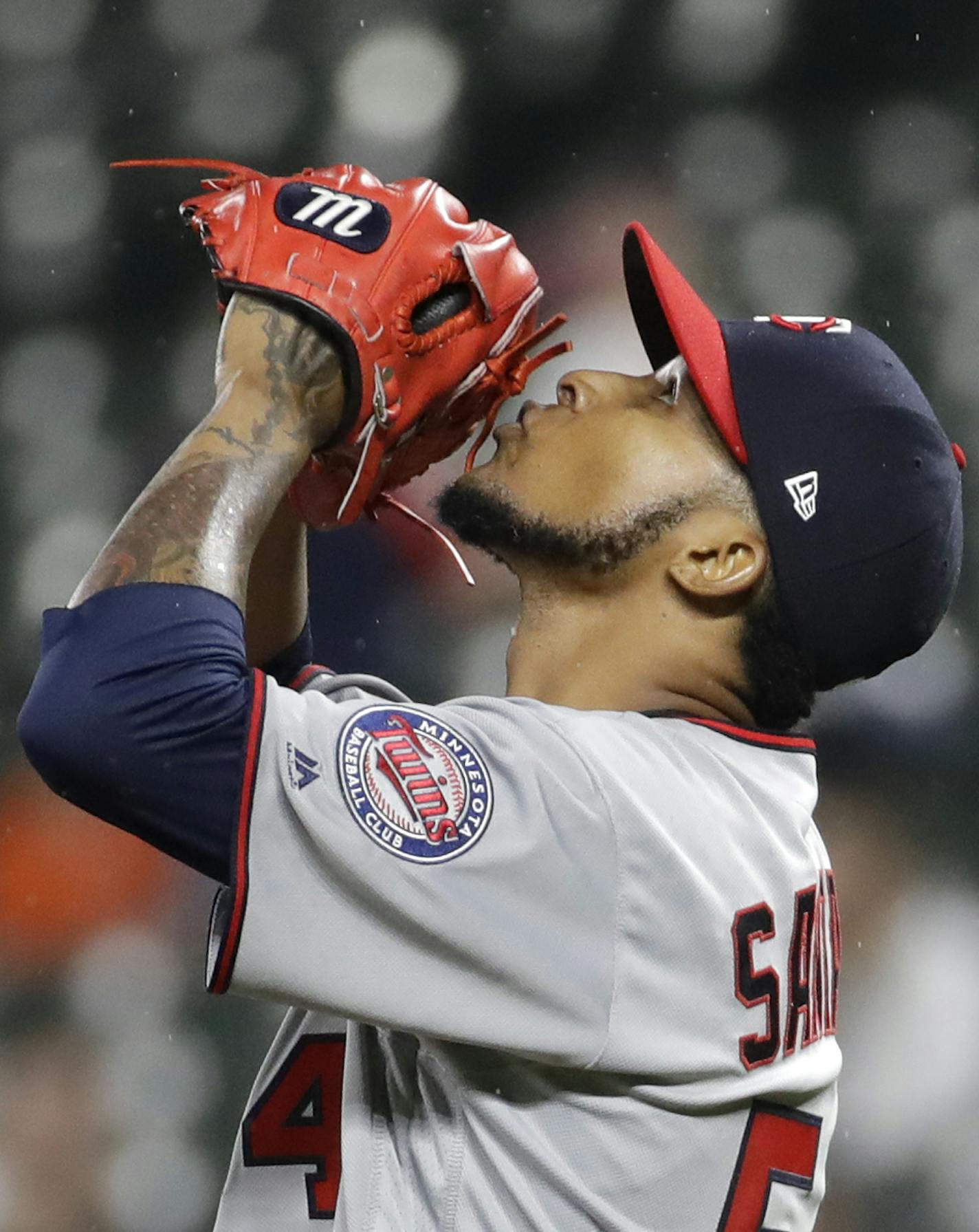 Minnesota Twins starting pitcher Ervin Santana kisses his glove after closing out a baseball game against the Baltimore Orioles in Baltimore, Tuesday, May 23, 2017. Santana pitched nine complete innings in Minnesota's 2-0 win. (AP Photo/Patrick Semansky)