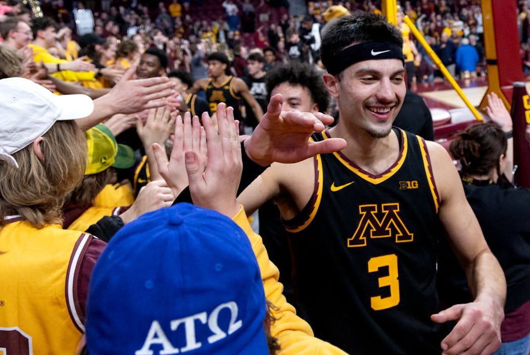 Gophers forward Dawson Garcia (3) celebrates with the student section Feb. 6 after a victory against Michigan State at Williams Arena.