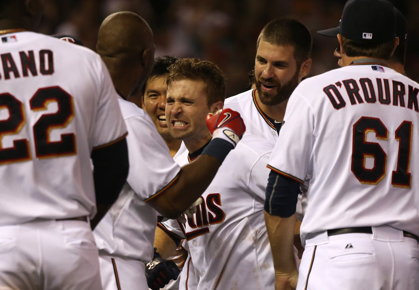 Brian Dozier, center, celebrated with his Twins teammates after his three-run homer capped a seven-run ninth inning.