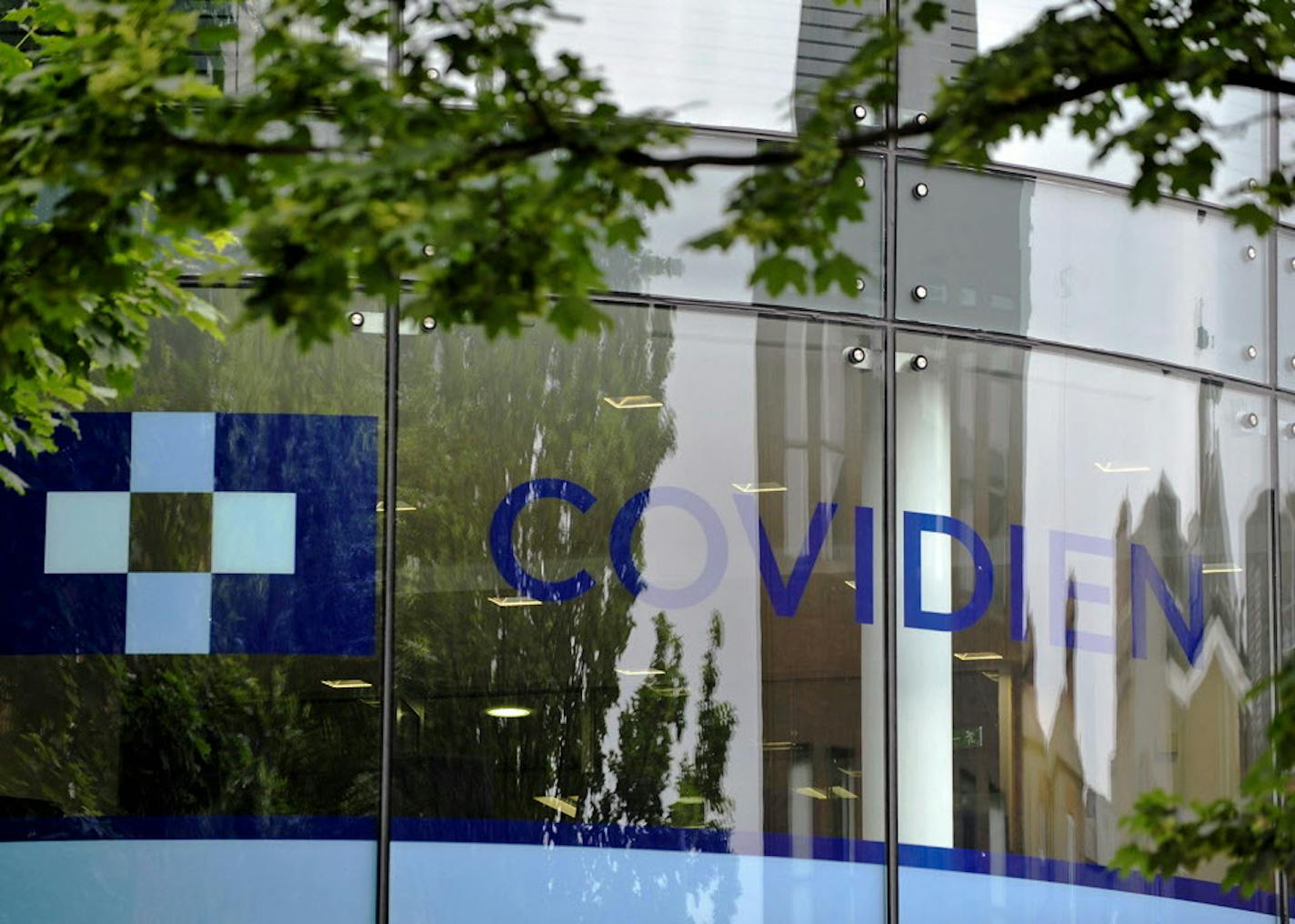 A Covidien logo sits on the glass windows of medical device manufacturer Covidien Plc's head office in Dublin, Ireland, on Monday, June 16, 2014. Medtronic Inc., the second-largest maker of medical devices, agreed to buy Covidien for $42.9 billion in cash and stock as it transforms into a broader-based company bolstered by new tax advantages. Photographer: Aidan Crawley/Bloomberg ORG XMIT: 498097627