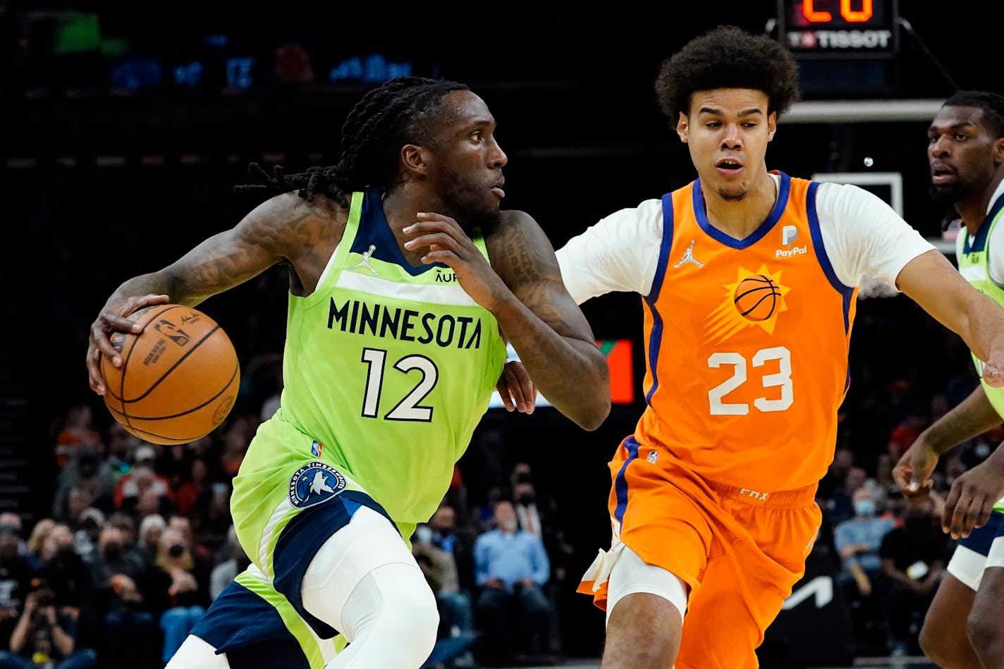 Timberwolves forward Taurean Prince drives as Suns forward Cameron Johnson defends during the first half Friday.