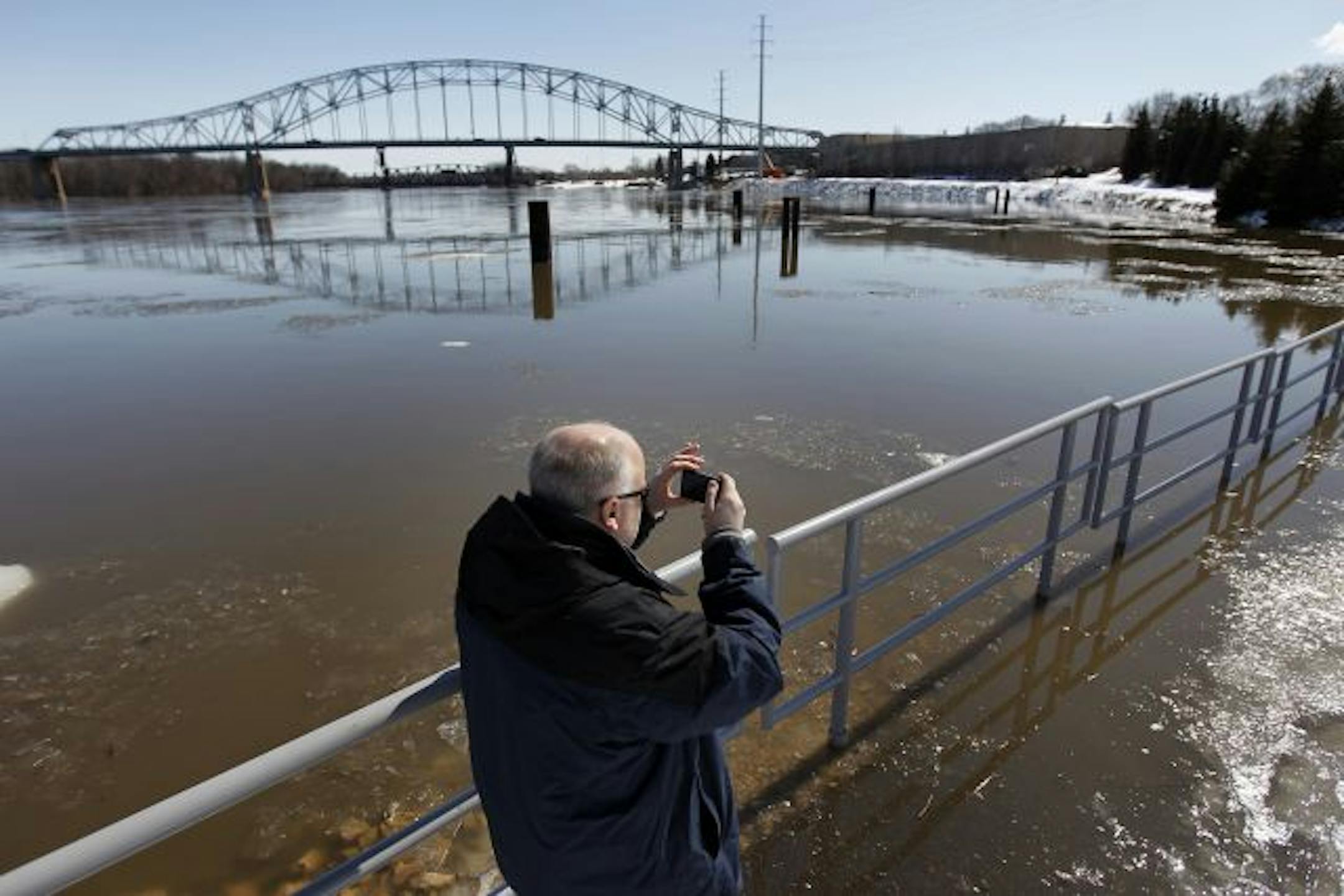 As river levels throughout the area climb, Kevin Westlund of Apple Valley snapped a photo of a flooded walking path near the Mississippi River in Hastings Sunday.