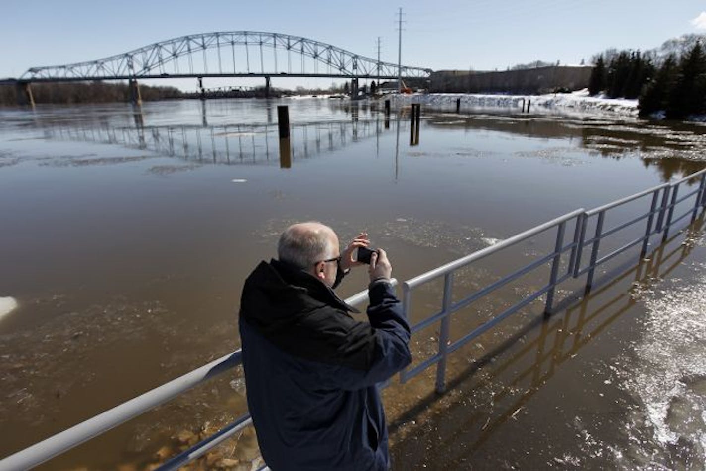 As river levels throughout the area climb, Kevin Westlund of Apple Valley snapped a photo of a flooded walking path near the Mississippi River in Hastings Sunday.