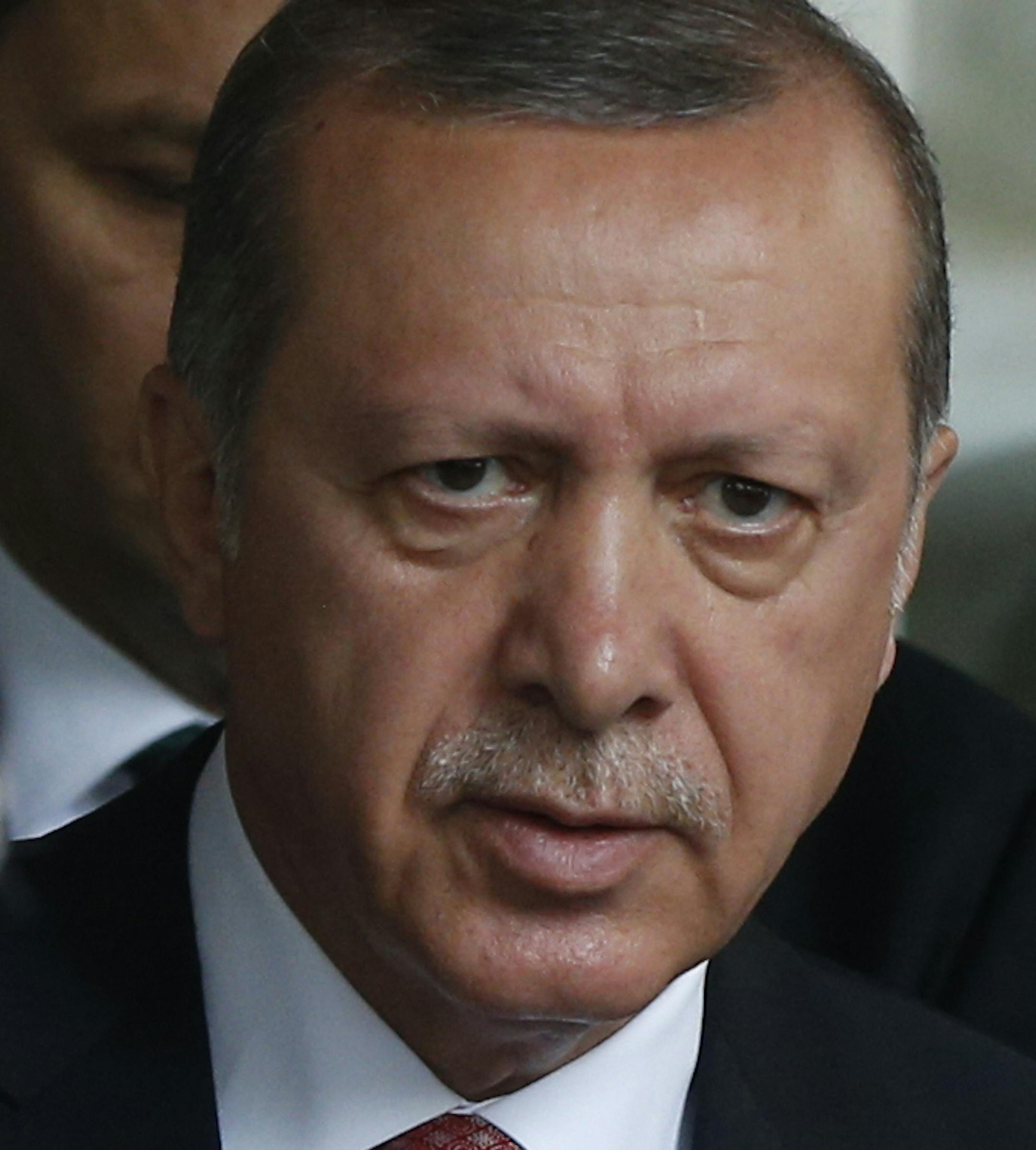 Turkey's President Recep Tayyip Erdogan walks outside a hospital after visiting wounded people, near an explosion site in Istanbul, Tuesday, June 7, 2016. A car bomb attack targeting a bus carrying riot police during rush hour traffic in Istanbul on Tuesday has killed number of people and wounded dozens others, the city's governor said. (AP Photo/Lefteris Pitarakis)