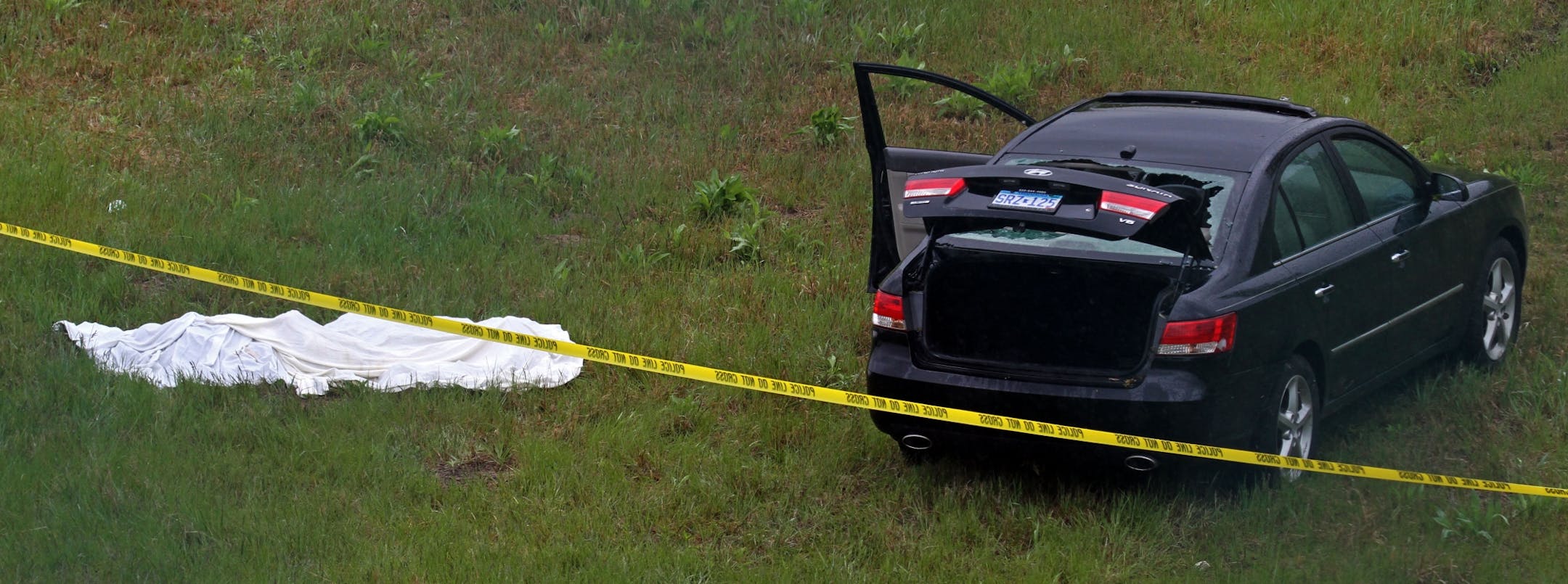 A body is covered with a sheet at the scene of the shooting at the intersection of Hwy 169 and Marschall in Shakopee.