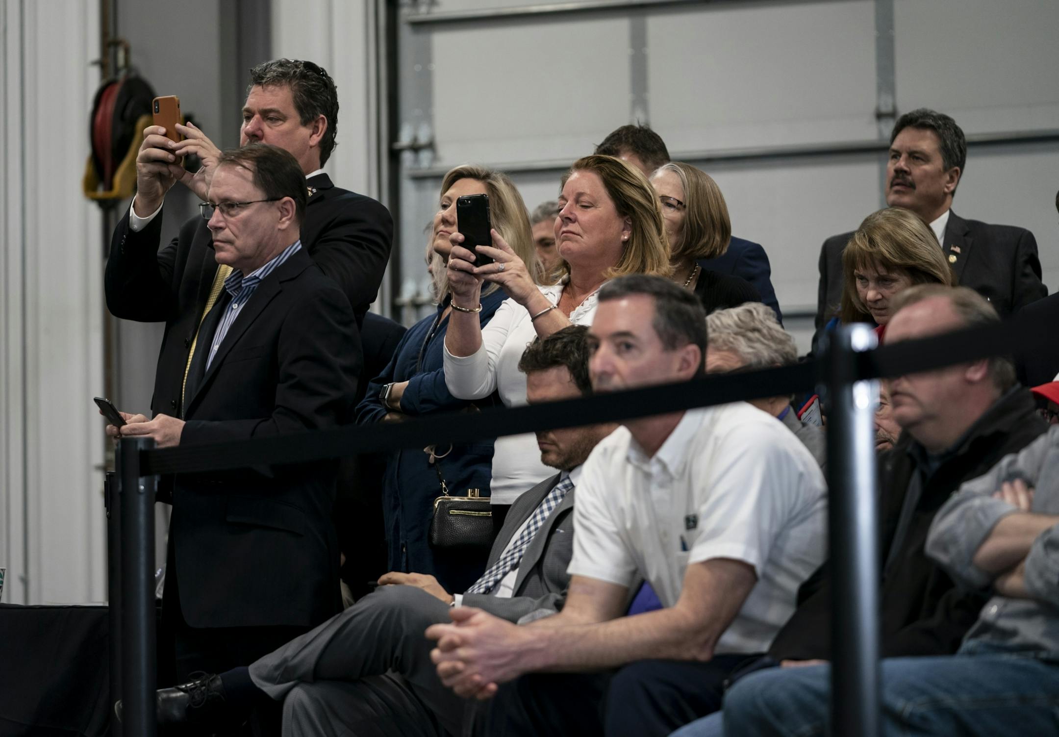 The crowd used their phones to record as President Donald J. Trump spoke at Nuss Truck and Equipment in Burnsville during a roundtable discussion on tax cuts and the U.S. economy in Burnsville, Minn., on Monday, April 15, 2019.