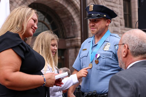 Minneapolis police officer Jacob Spies, was joined by his daughter, Olivia, and his wife, Holly, at the ceremony awarding him MPD's first Purple Heart