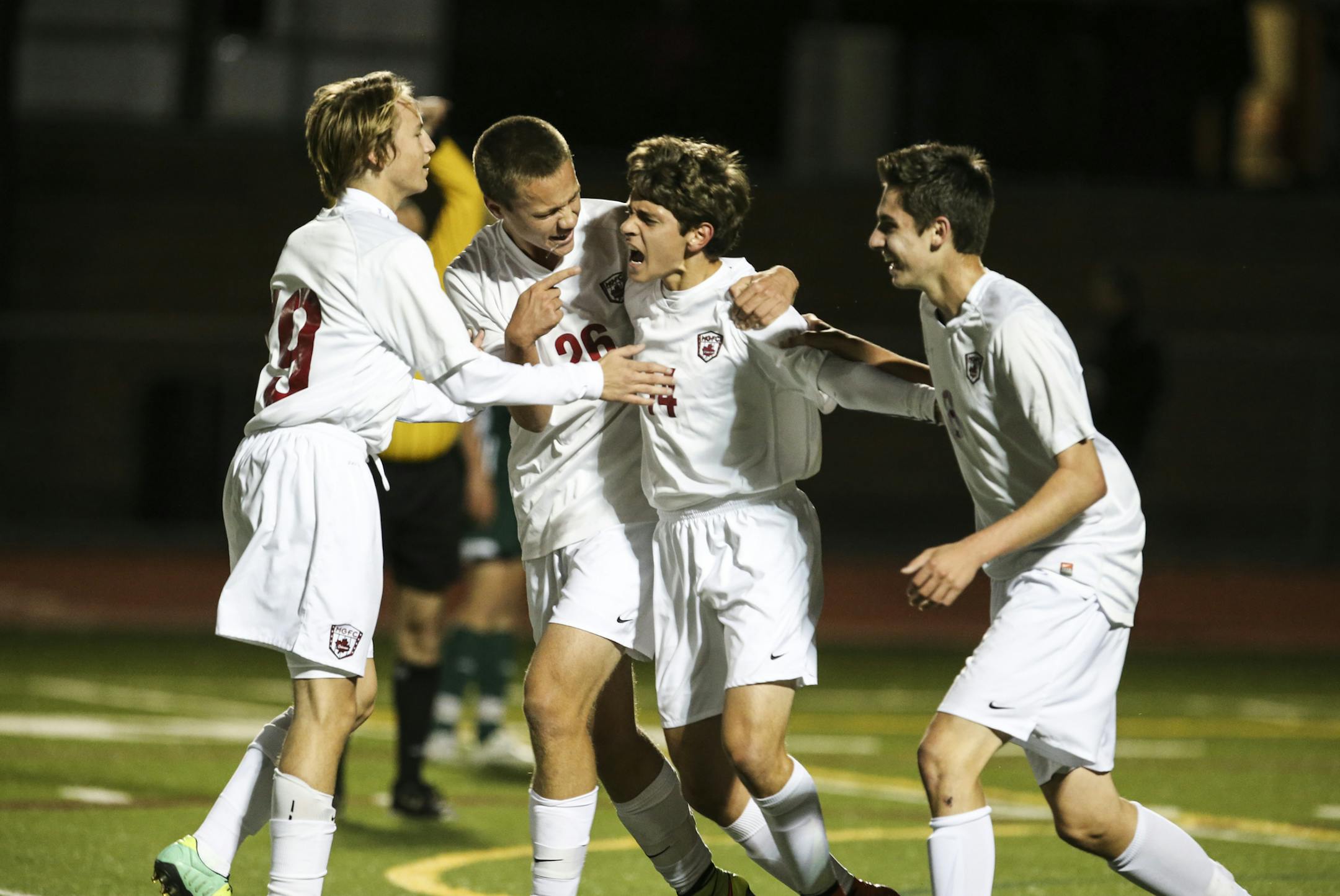 Maple Grove teammates hugged Daniel Cortez (14) after he scored his second goal during the Class 2A, Section 5 boys’ soccer championship game.