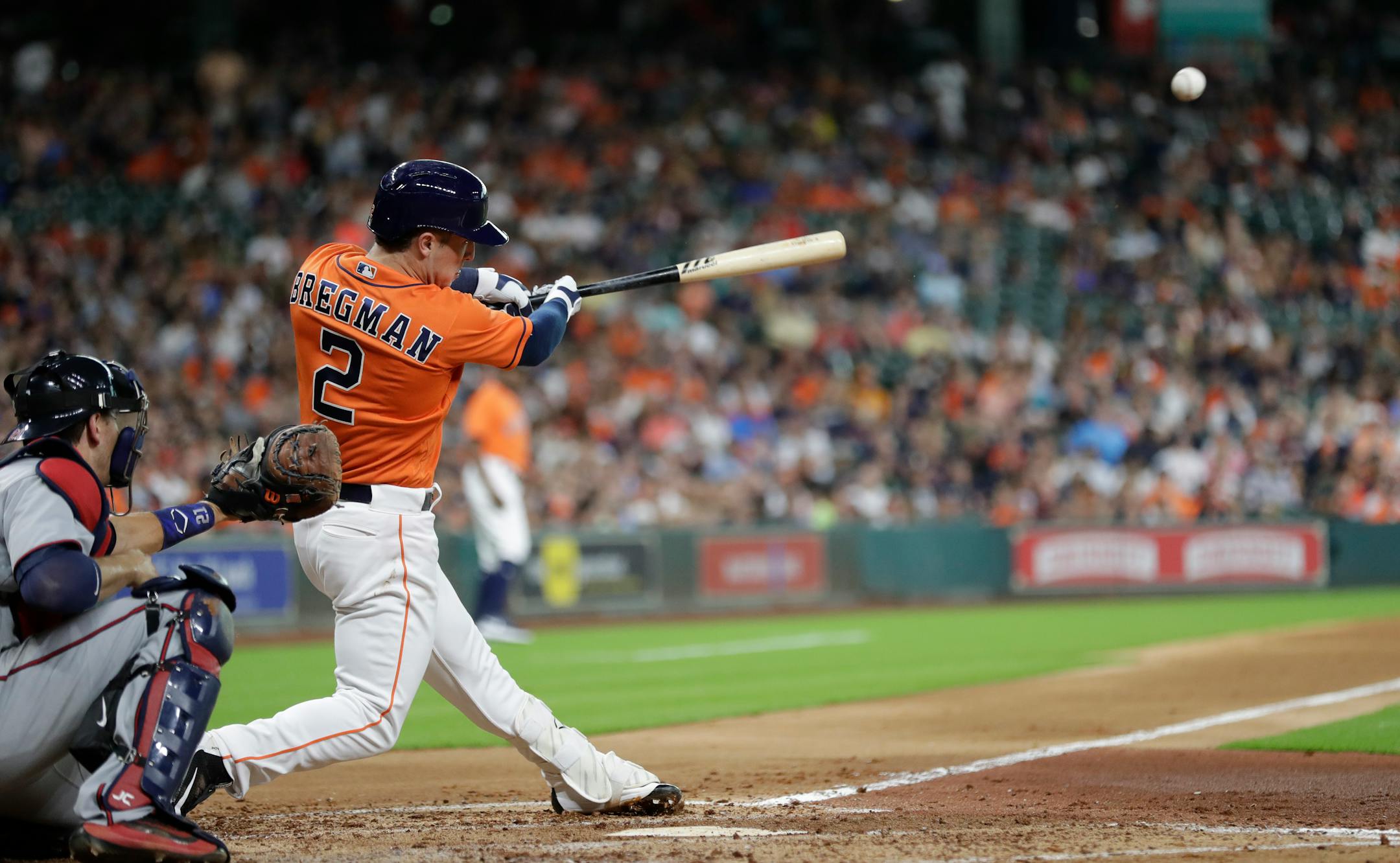 Houston Astros' Alex Bregman hits an RBI double to score Yuli Gurriel as Minnesota Twins catcher Jason Castro watches during the second inning of a baseball game Friday, July 14, 2017, in Houston. (AP Photo/David J. Phillip)