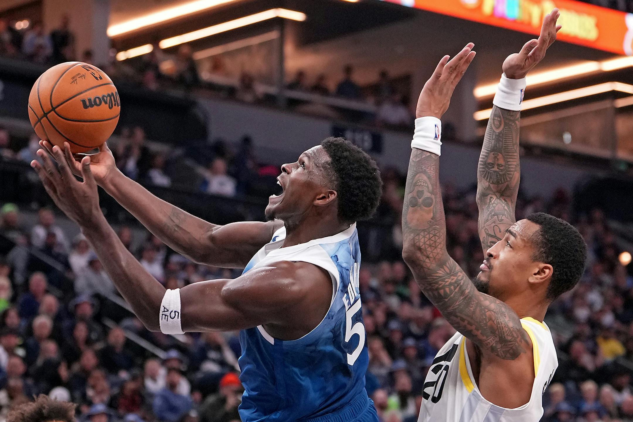Minnesota Timberwolves guard Anthony Edwards (5) shoots as Utah Jazz forward John Collins (20) defends during the second half of the game.