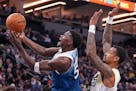 Minnesota Timberwolves guard Anthony Edwards (5) shoots as Utah Jazz forward John Collins (20) defends during the second half of the game.
