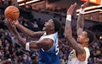 Minnesota Timberwolves guard Anthony Edwards (5) shoots as Utah Jazz forward John Collins (20) defends during the second half of the game.
