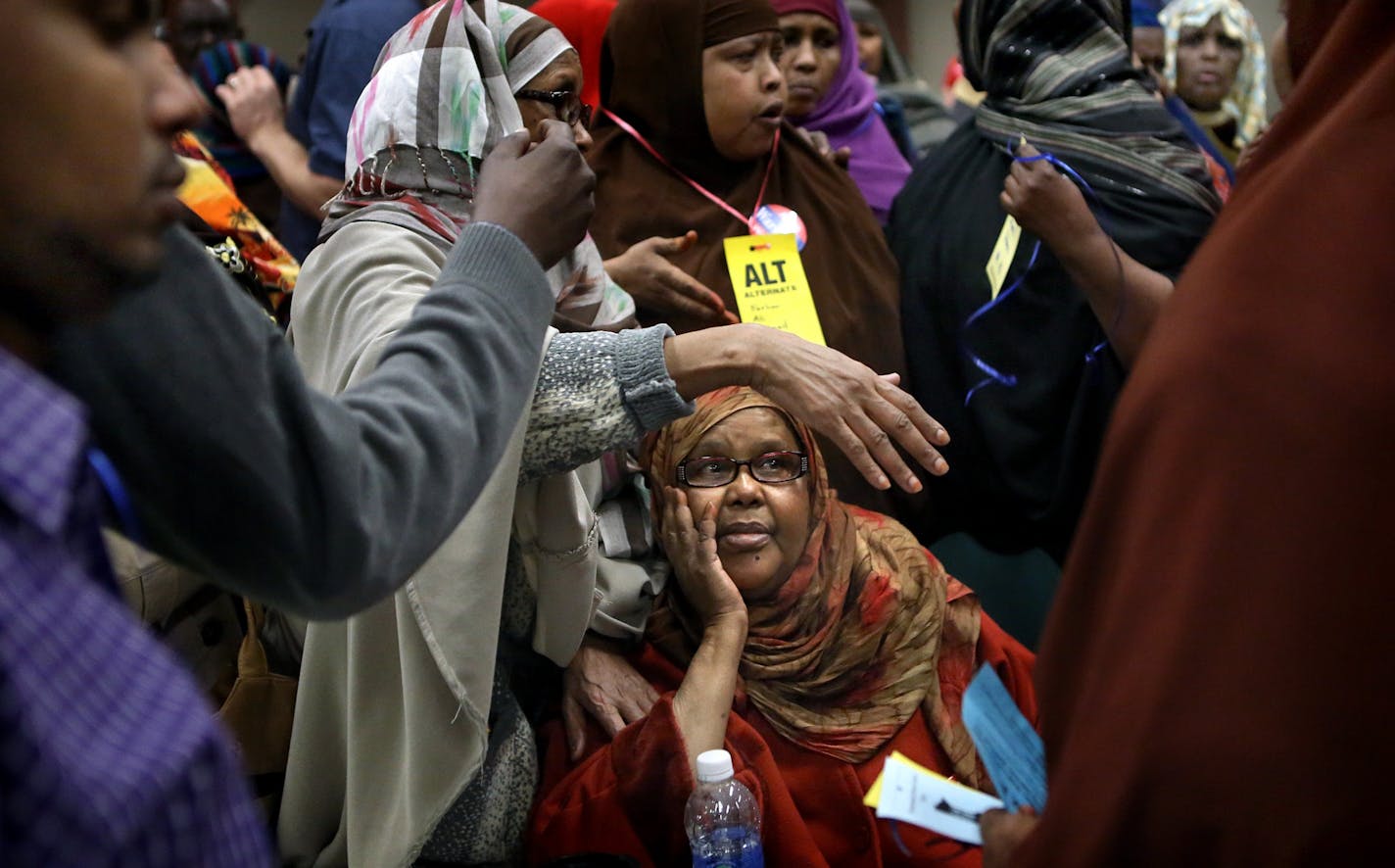 Women in Muslim dress waited in line during a process of upgrading alternates to delegates that became congested as names were being checked and verified.