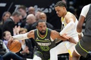 Timberwolves guard Mike Conley drives around Jazz guard Keyonte George during the first half Saturday in Salt Lake City.