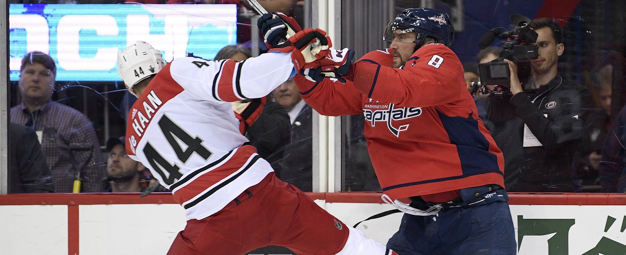 Washington Capitals left wing Alex Ovechkin (8), of Russia, shoves Carolina Hurricanes defenseman Calvin de Haan (44) during the second period of Game 7 of an NHL hockey first-round playoff series, Wednesday, April 24, 2019, in Washington. (AP Photo/Nick Wass)