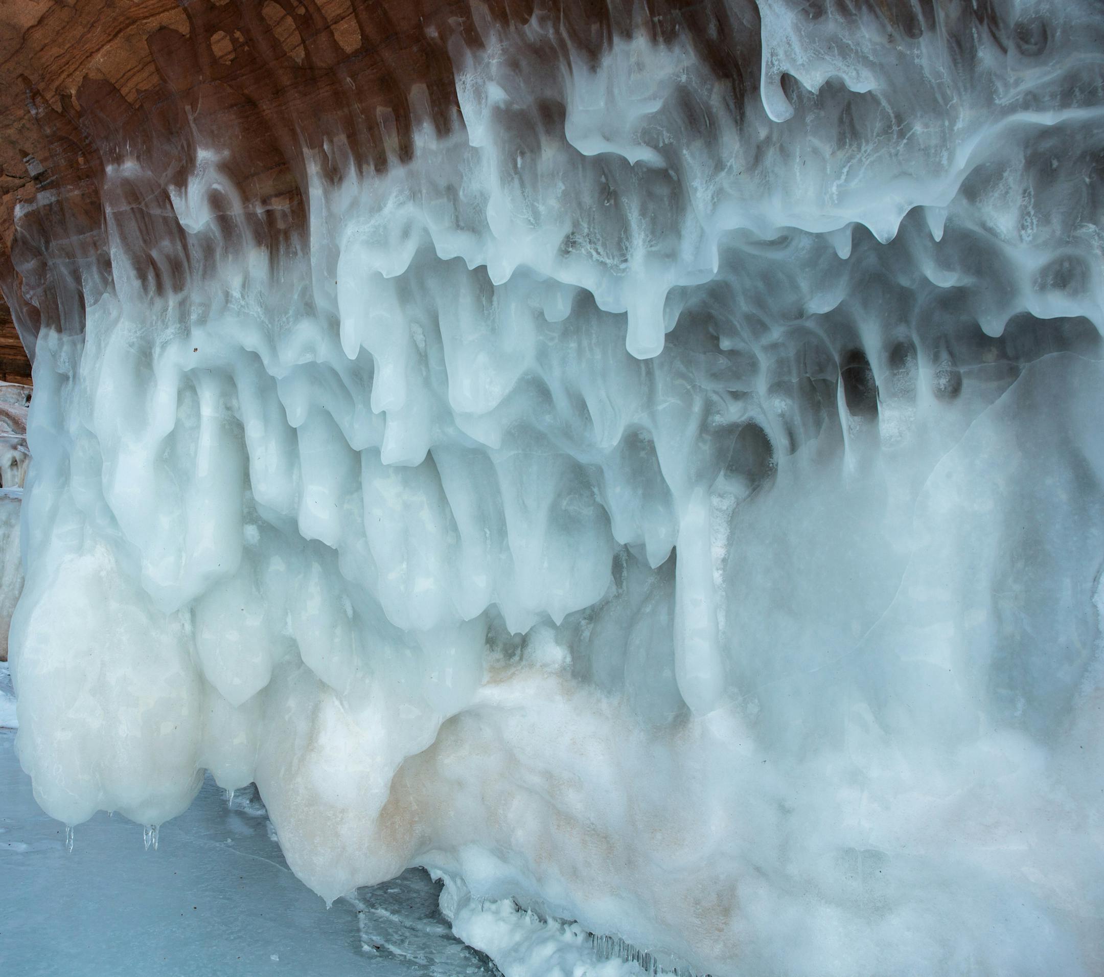 A person explores an ice cave at the Apostle Islands National Lakeshore on Lake Superior, Friday, Feb. 27, 2015, near Bayfield, Wis. (Zbigniew Bzdak/Chicago Tribune) ORG XMIT: MIN2015022715523916