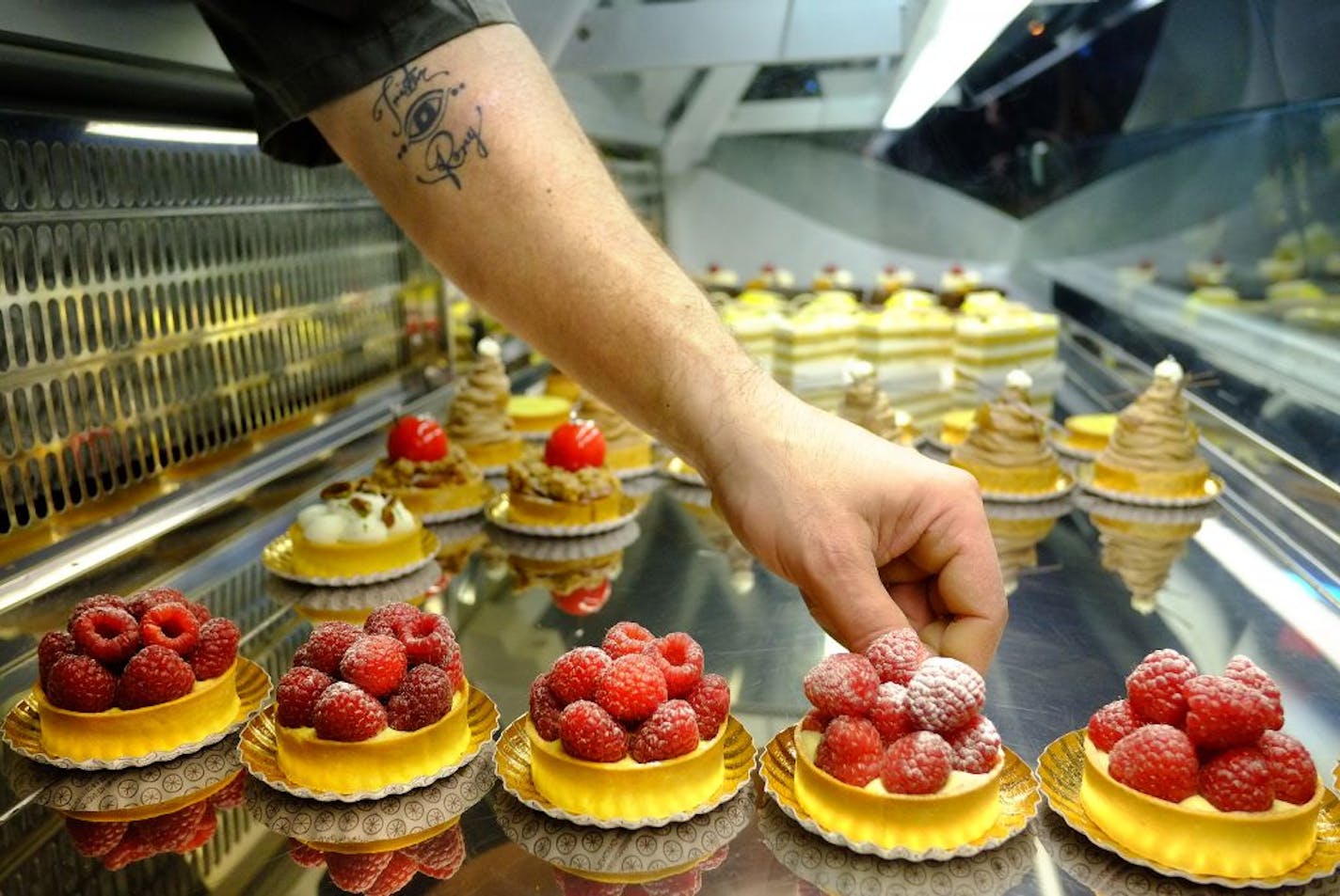 A "Great Chefs" profile of Patisserie 46 chef/owner John Kraus. The bakery restaurant is on the corner of 46th and Grand in South Minneapolis _ John Kraus helps the staff fill the display case about 5:30 Staurday Morning.[ TOM WALLACE � twallace@startribune.com _ Assignments #20026490A_ Dec 1, 2012_ SLUG: chef1213_ EXTRA INFORMATION: Signature sweet, from the Minneapolis, French bakery, Patisserie 46, The staff; Owner/artisian baker, John Kraus, Wife, Dawn Kraus, Jason Curry, Ashley Johnson, Mar