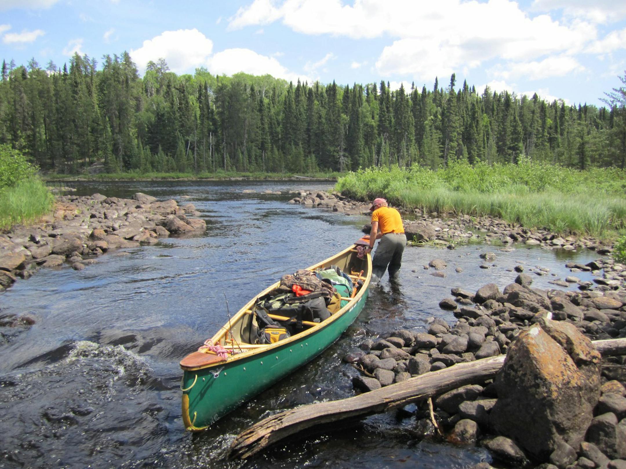 Moving the canoe out into the riverway in Wabakimi Provincial Park in Ontario.
